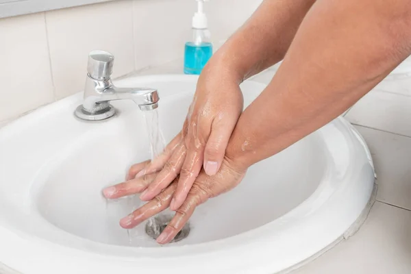 Men's hands wash their hands with soap clean hands in the tub with soap, personal hygiene.
