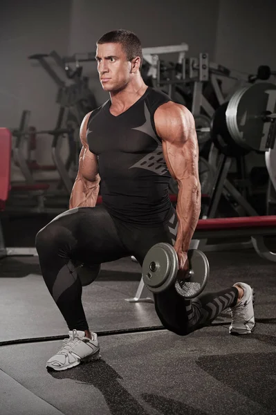 Handsome Muscular Men Doing Lunges, Leg Exercise With Dumbbells in the Gym