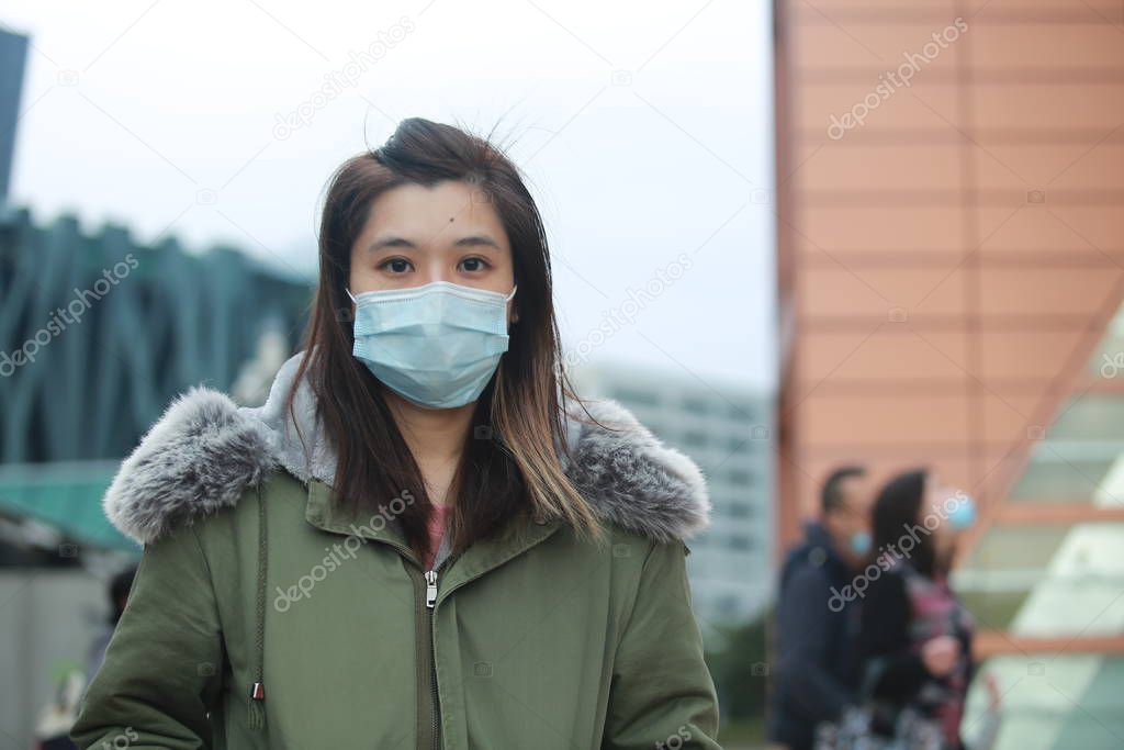masked girl to protect herself from wuhan virus in public area