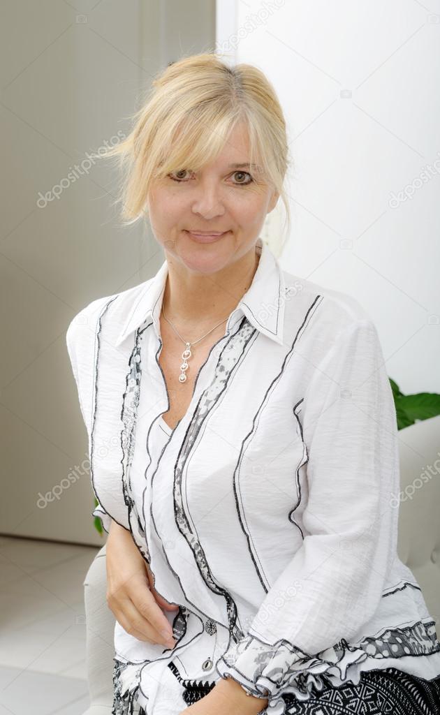 Portrait of mature smiling blond woman