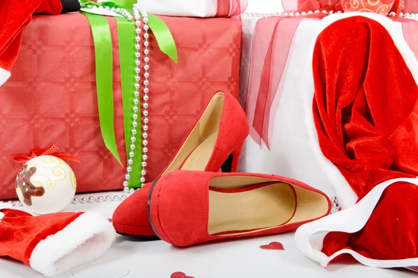 The Christmas gift boxes and woman shoes — Stock Photo, Image