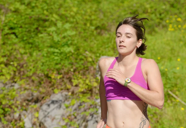 Beautiful athletic woman running in countryside — Stock Photo, Image