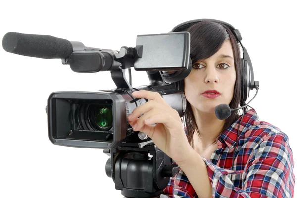 Pretty young brunette girl with a professional camcorder, on whi — Stock Photo, Image