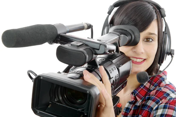 Pretty young brunette girl with a professional camcorder, on whi — Stock Photo, Image