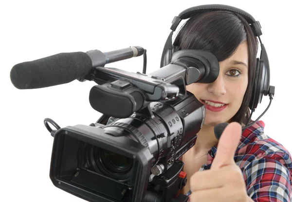 Pretty young brunette girl with a professional camcorder, on whi — Stock Photo, Image
