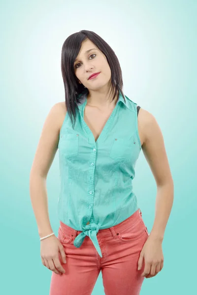 Young brunette with a green shirt and pink pants — Stock Photo, Image