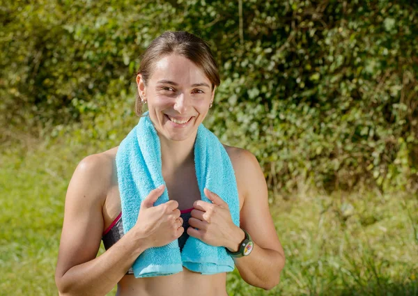 Young sporty woman with blue towel in the countryside — Stock Photo, Image