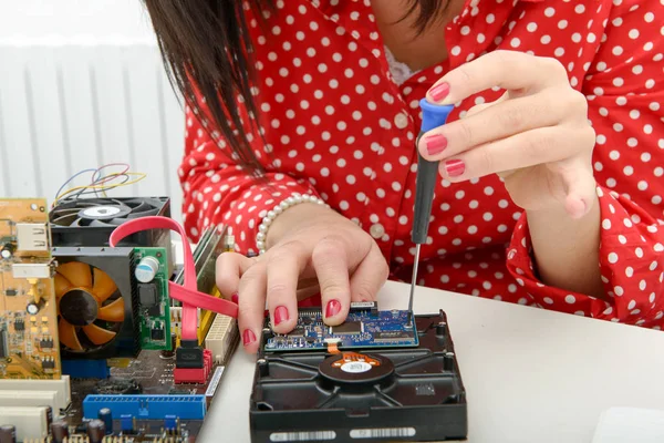 woman technician repairs a computer