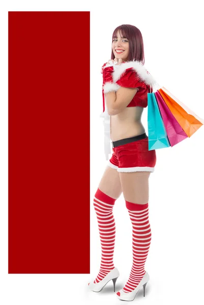 Menina bonita vestida como Papai Noel com presentes de Natal — Fotografia de Stock