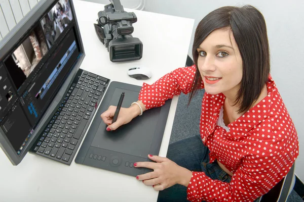 Young female designer using graphics tablet for video editing — Stock Photo, Image