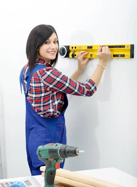 brunette woman using spirit level