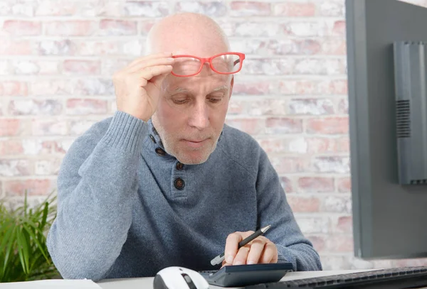 Businessman having eyesight problems, he is using calculator — Stock Photo, Image