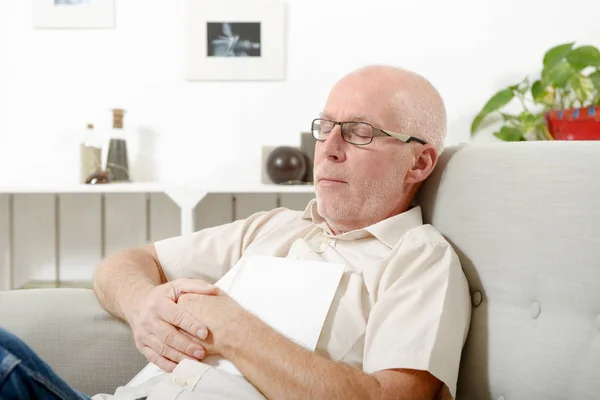 Mature man taking a nap in sofa at home — Stock Photo, Image