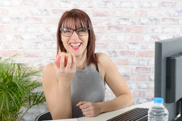 Mooie jonge zakenvrouw eet een appel — Stockfoto