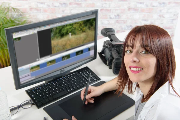 Young female designer using computer for video editing — Stock Photo, Image