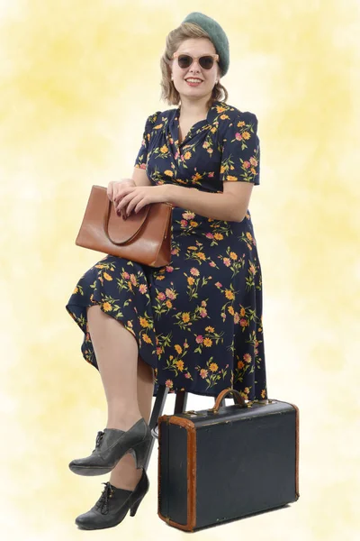 beautiful woman with vintage clothes sitting on chair