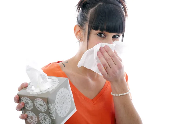 Sick young girl blowing her nose on white — Stock Photo, Image