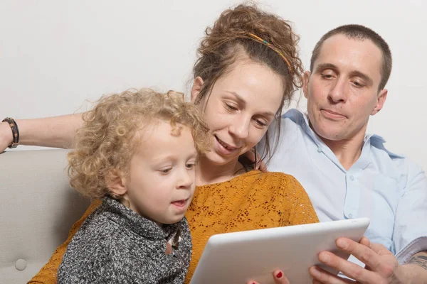 Happy family playing with a tablet computer — Stock Photo, Image
