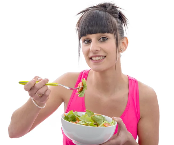 Jonge brunette sportieve vrouw eet salade — Stockfoto