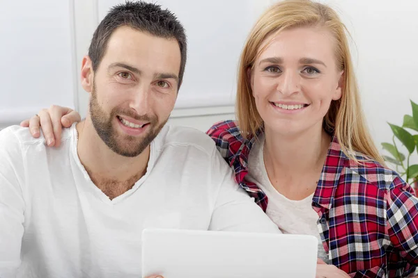 Happy young couple using digital tablet — Stock Photo, Image