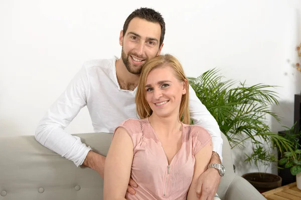 Young couple resting in the sofa — Stock Photo, Image
