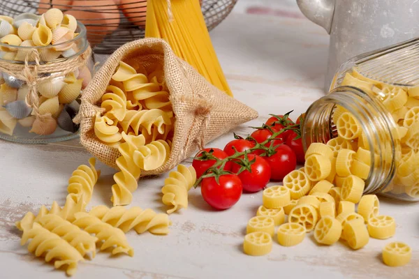 Raw pastas with cherry tomatoes — Stock Photo, Image