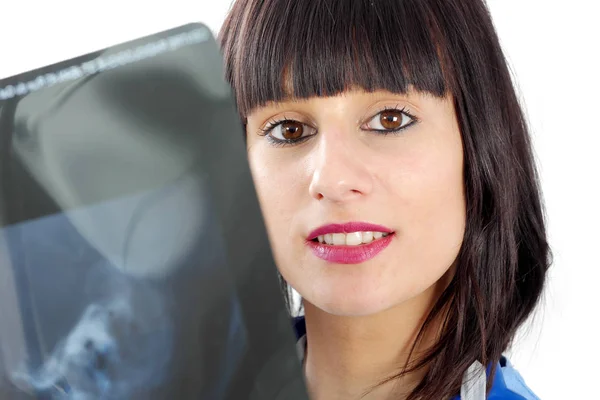 Young female doctor looking at patients x-ray — Stock Photo, Image