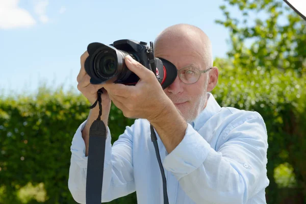 Mature man using camera dslr — Stock Photo, Image