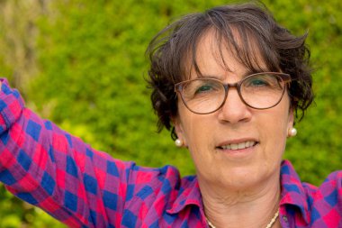 Gözlük, açık olan bir olgun esmer kadın portresi