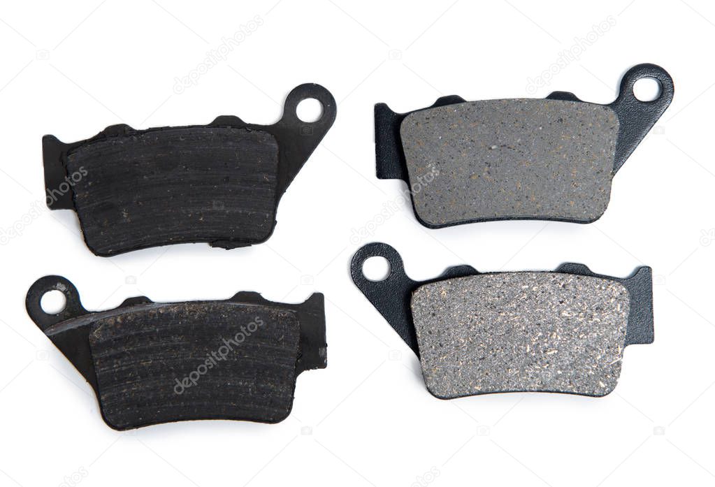 New and used brake pads for motorcycle on white