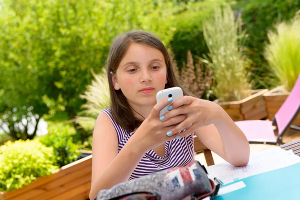Pre teenager girl texting on mobile phone — Stock Photo, Image
