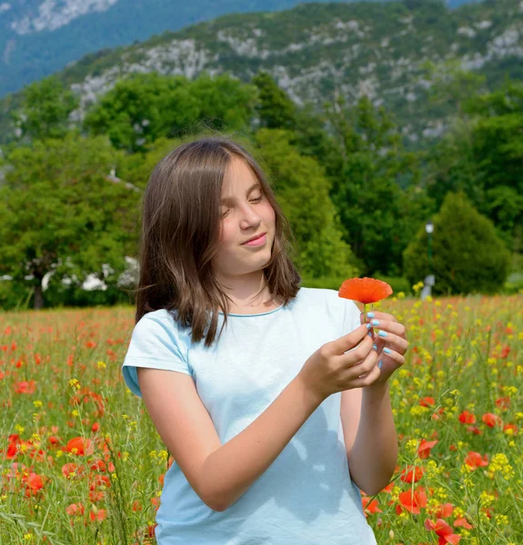 年轻十几岁的女孩在罂粟的领域 — 图库照片