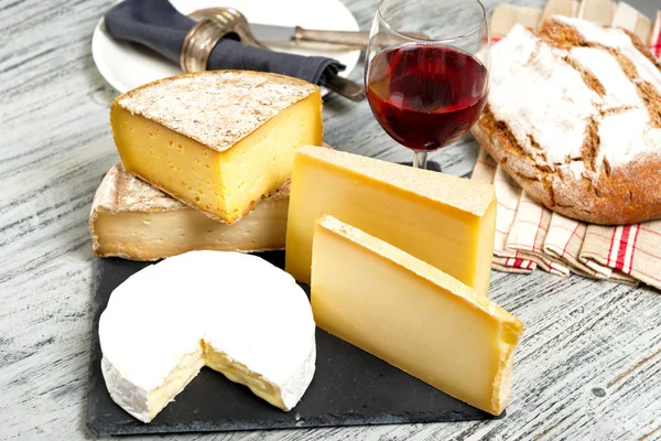 Διάφορα Γαλλικά τυριά με ένα ποτήρι κρασί — Φωτογραφία Αρχείου