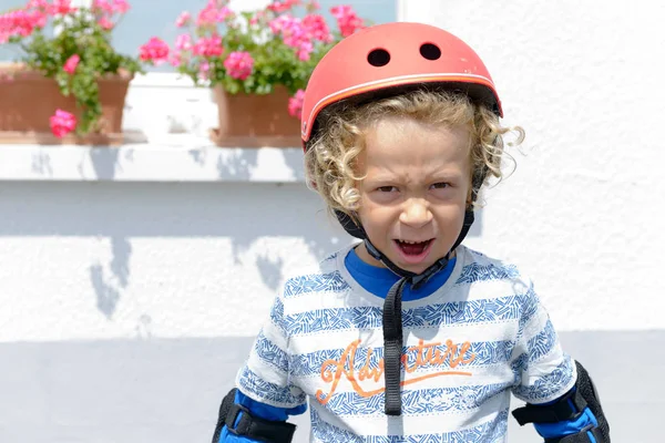 Porträtt av en liten blond pojke med skridsko hjälm — Stockfoto