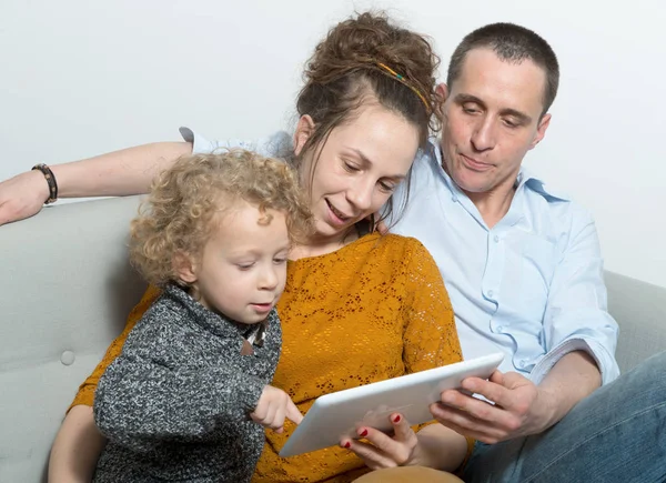 Happy family using a tablet — Stock Photo, Image