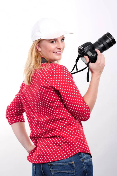 Pretty blonde woman photographer with her camera, on white — Stock Photo, Image