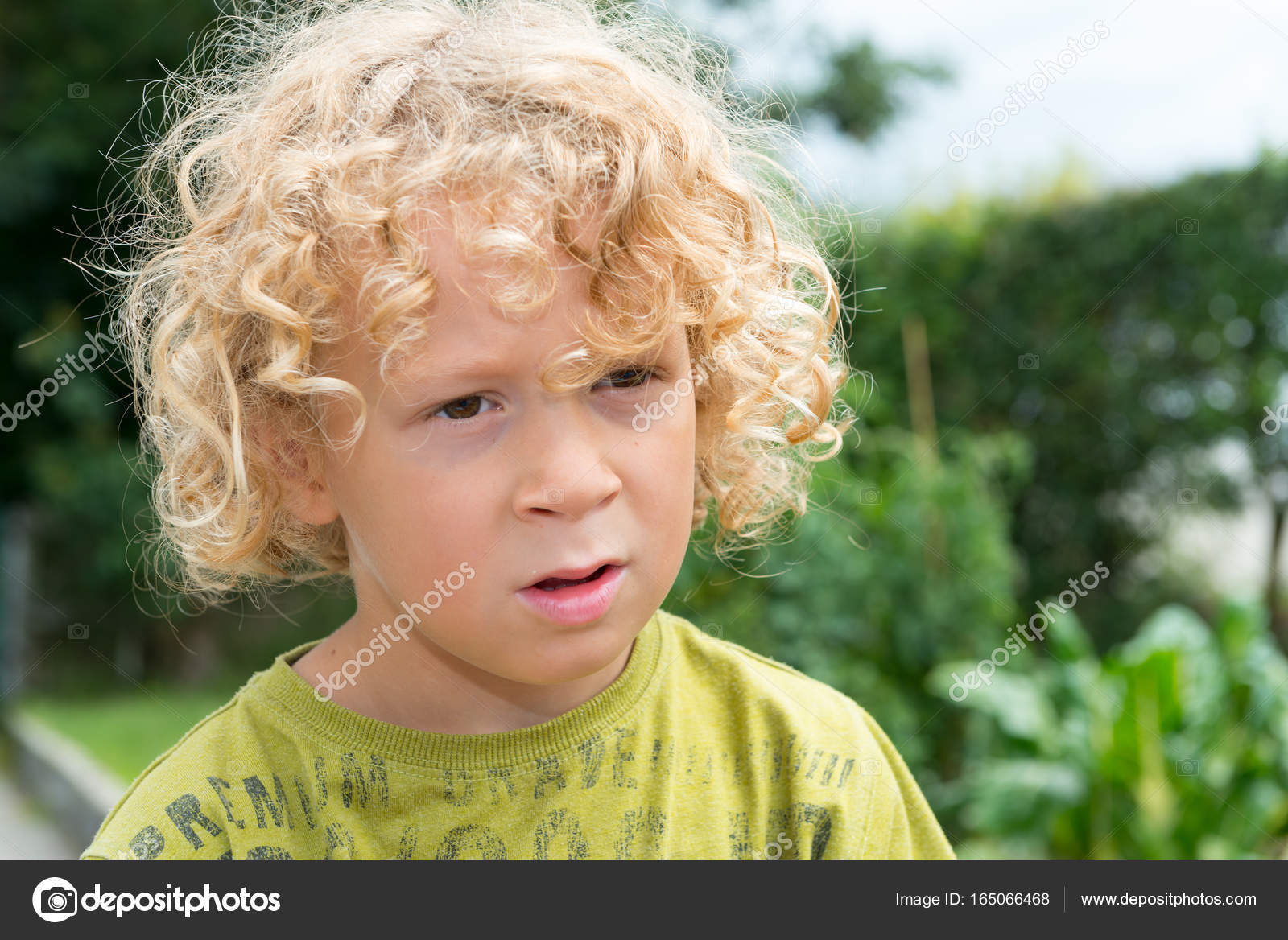 Portrait Of Little Boy With Blond And Curly Hair Stock Photo