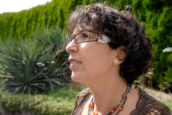 Portrait d'une femme brune d'âge moyen avec des lunettes, outdoo — Photo