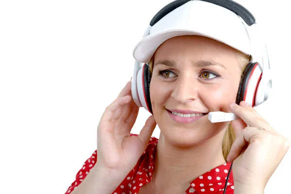 Blond young woman with headset and white cap — Stock Photo, Image