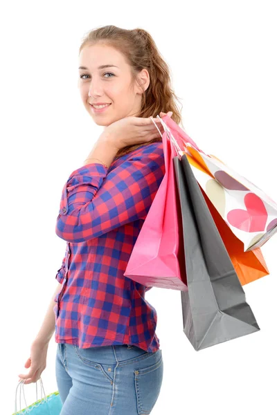 Mujer joven con muchas bolsas de compras sobre fondo blanco — Foto de Stock