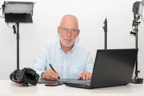 Hombre trabajando en su tableta gráfica y portátil — Foto de Stock