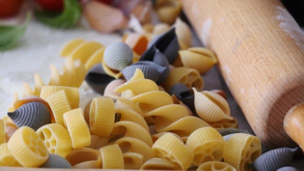 Raw pasta and cherry tomatoes — Stock Video