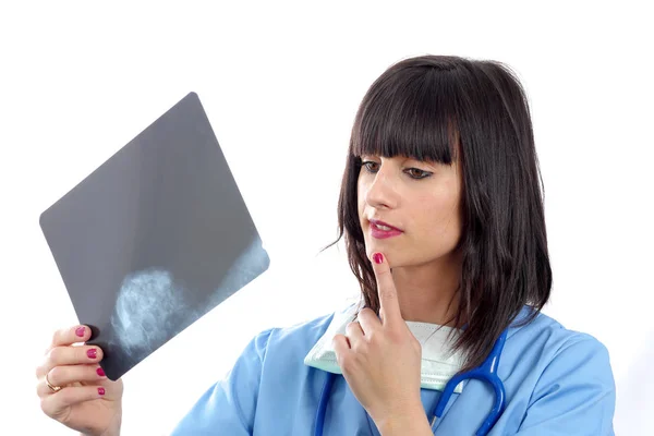 Young female doctor looking at patients x-ray — Stock Photo, Image