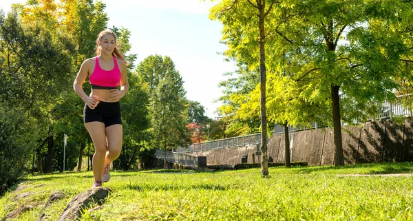 Beautiful young woman run in nature