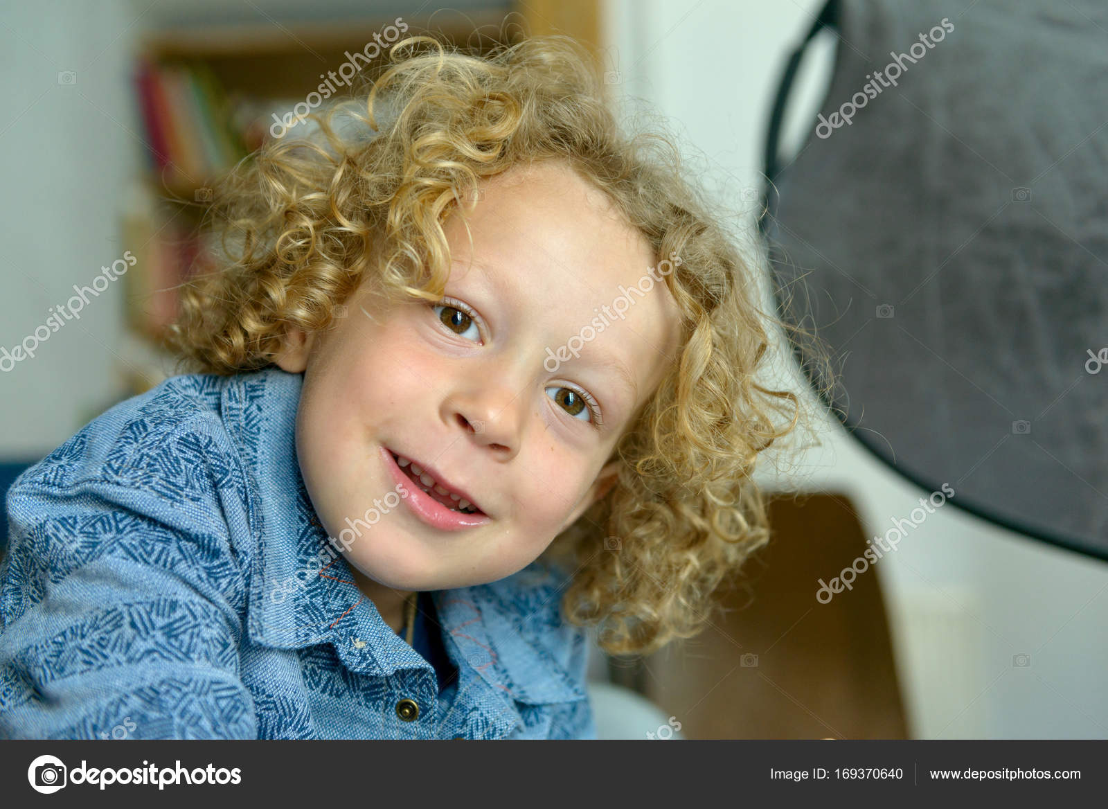 Portrait Of Little Boy With Blond And Curly Hair Stock Photo
