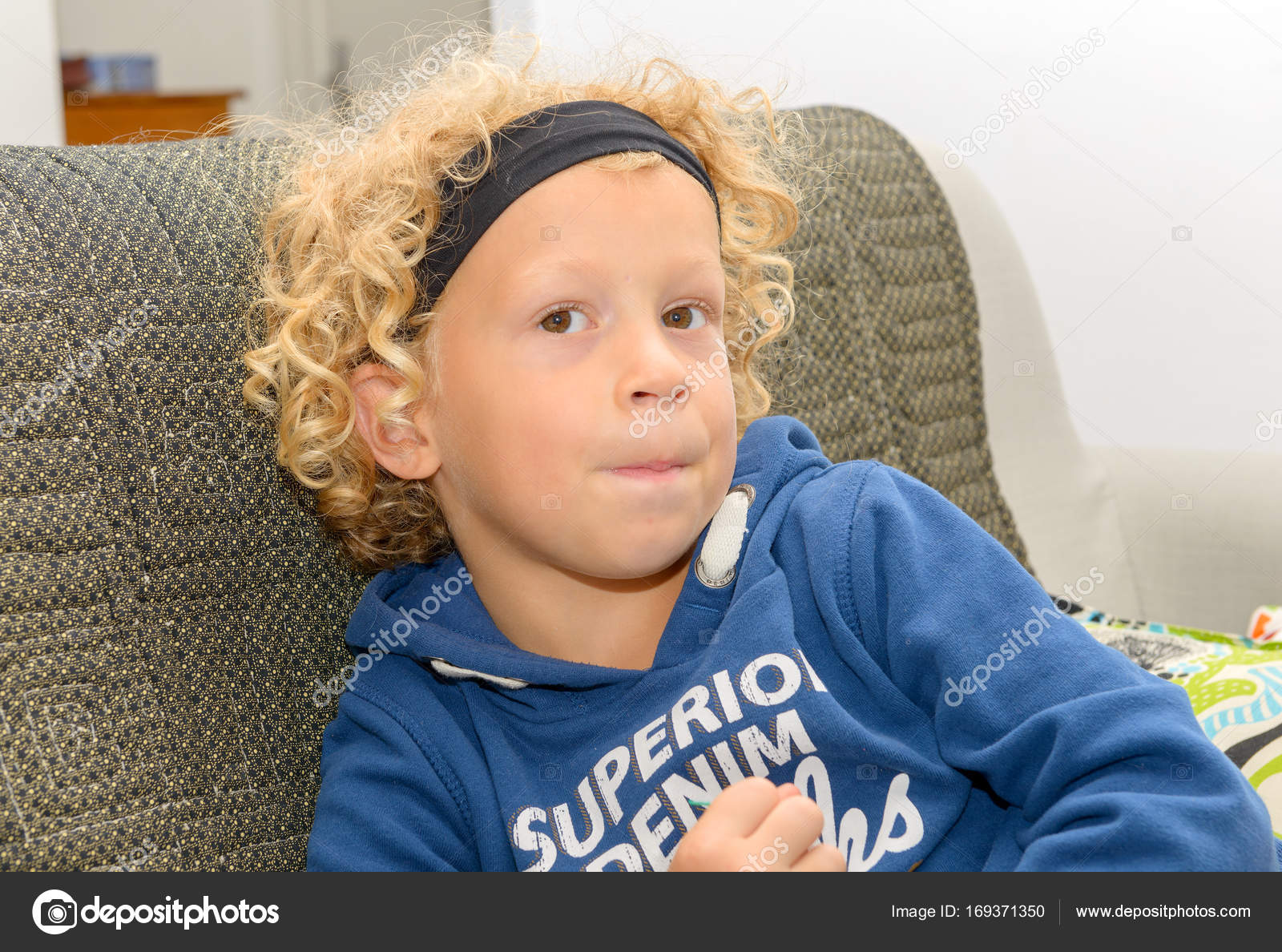 Portrait Of Little Boy With Blond And Curly Hair Stock Photo