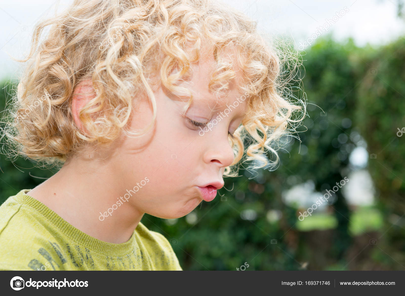 Portrait Of Little Boy With Blond And Curly Hair Stock Photo