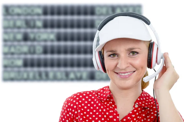 Blond young woman with headset and white cap — Stock Photo, Image