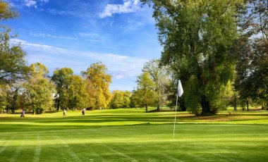 Yeşil golf alanı ve bulutlu gökyüzü mavi