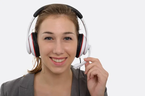 Mooie jonge vrouw met een headset, op witte glimlachen — Stockfoto
